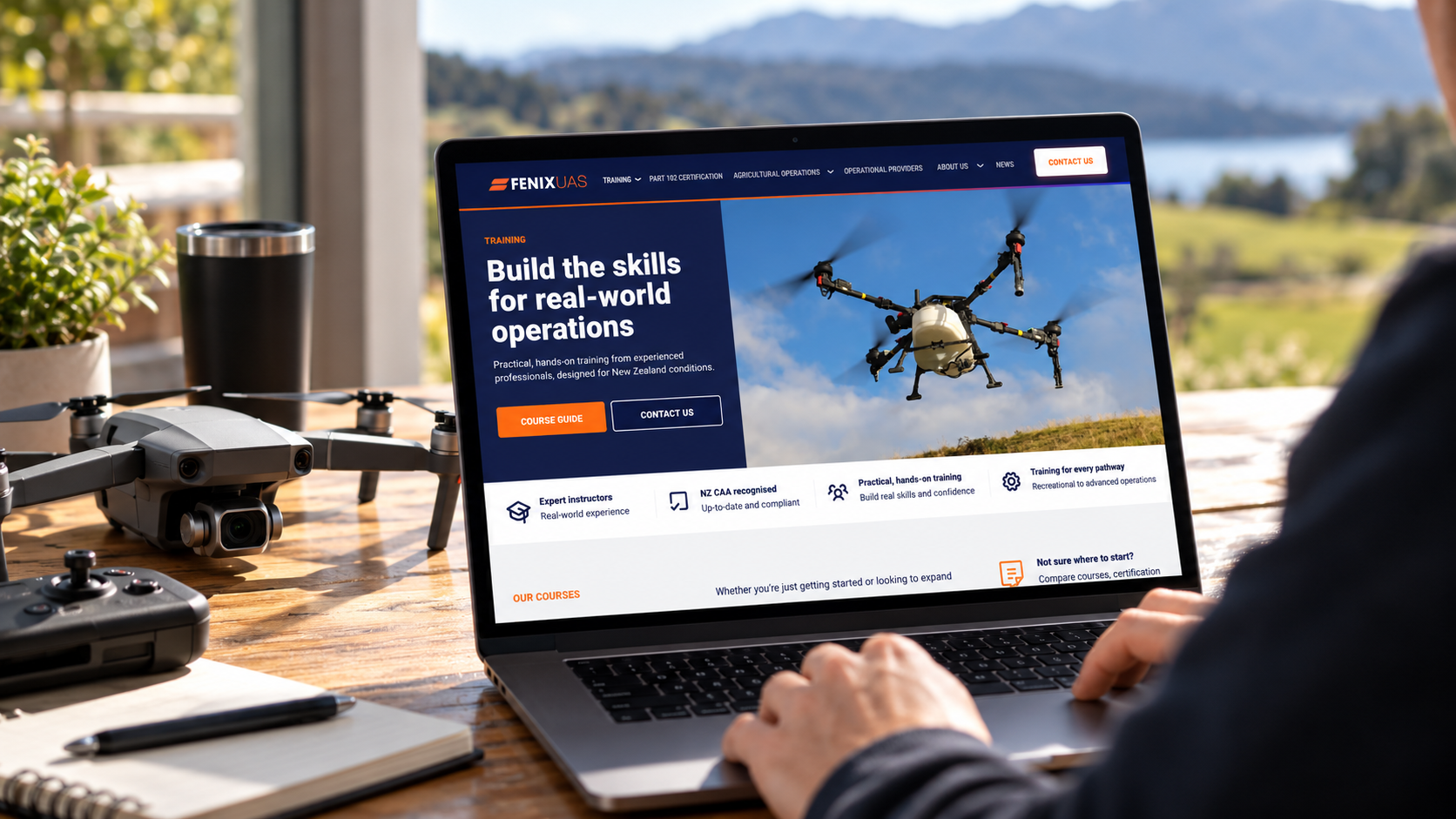 Drone and controller beside a laptop displaying the Fenix UAS training website, featuring drone pilot courses in New Zealand.